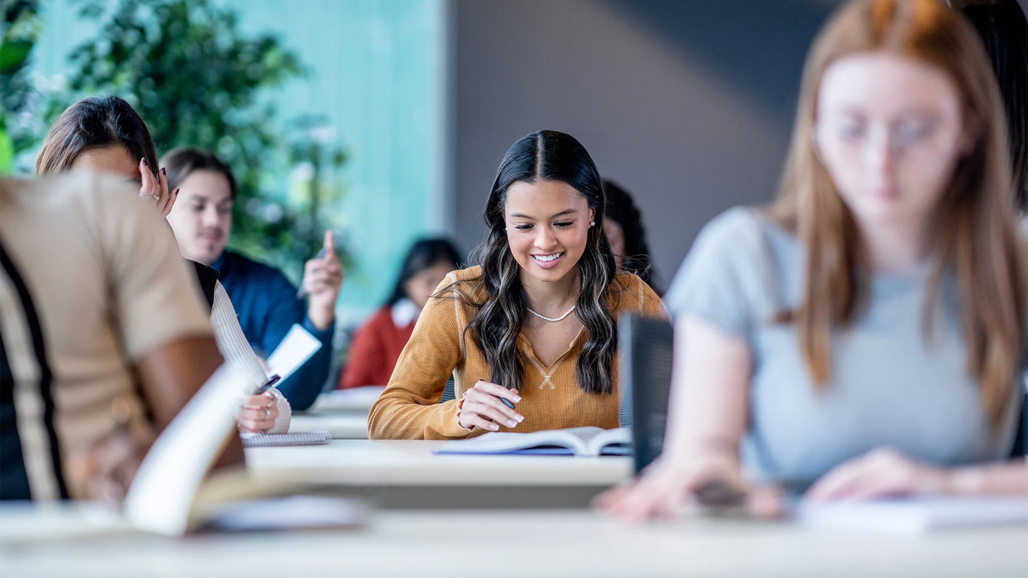 Students sitting in bright class room doing exam